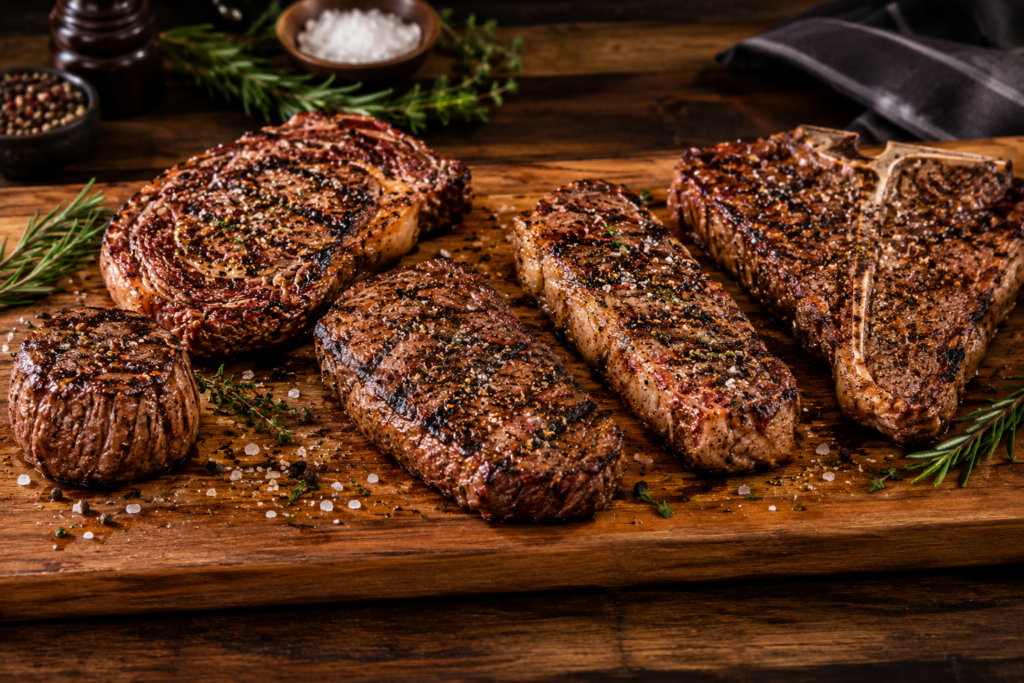 Different LongHorn steak cuts with seasoning and grilled crust